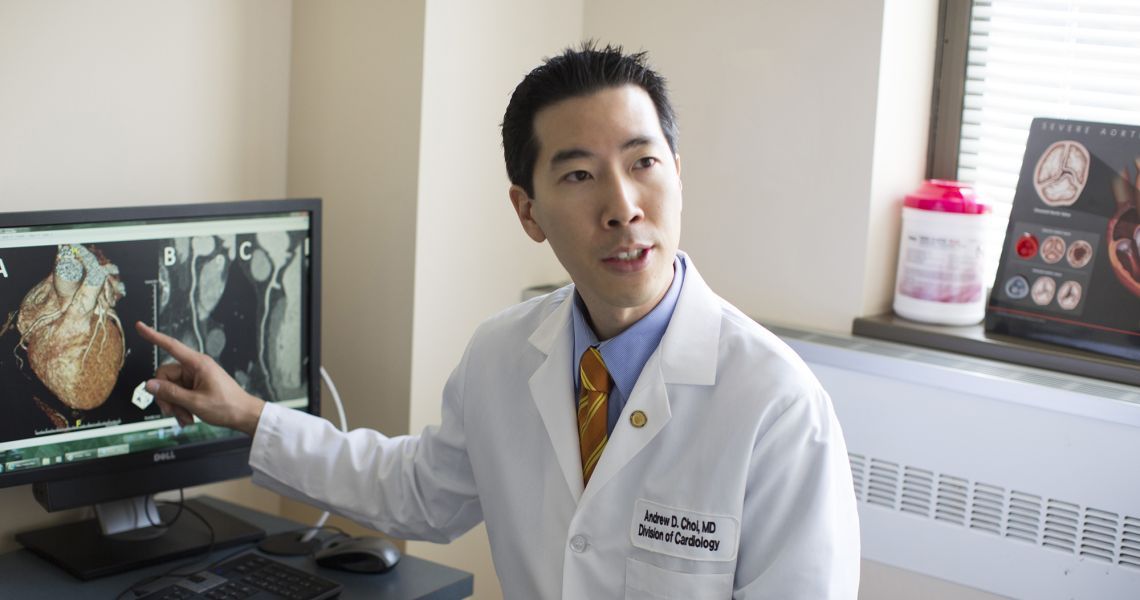 Andrew Choi pointing to a computer screen