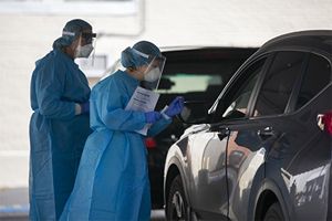 Two medical professionals assisting with COVID-testing