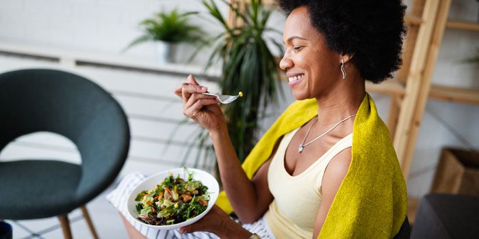 happy woman eating a healthy meal