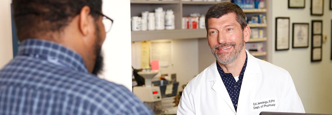 patient speaking with pharmacist