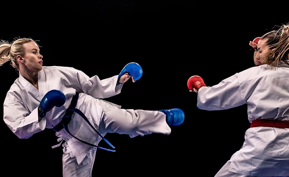 Two taekwondo practitioners sparring
