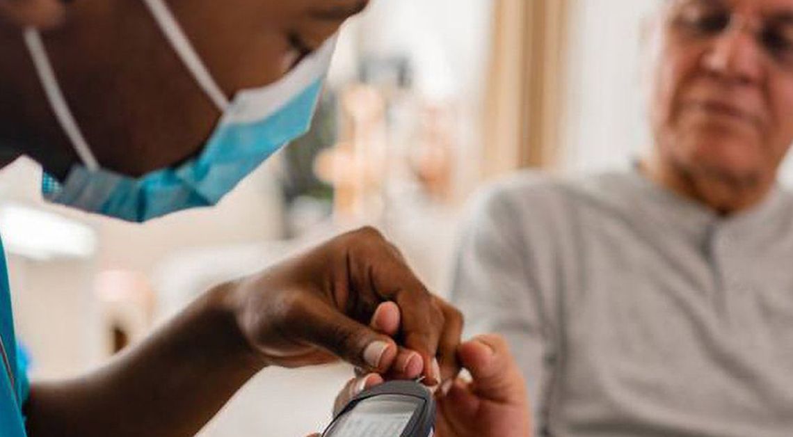 physician taking someone's blood glucose readings