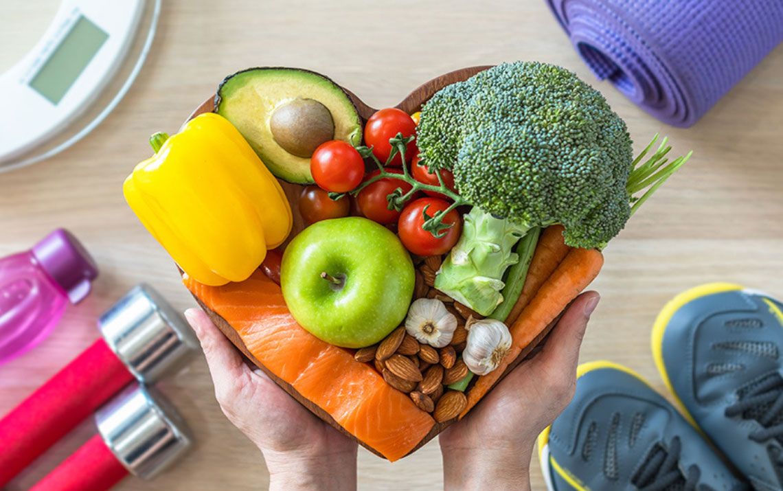 fruits and veggies in a heart shaped bowl