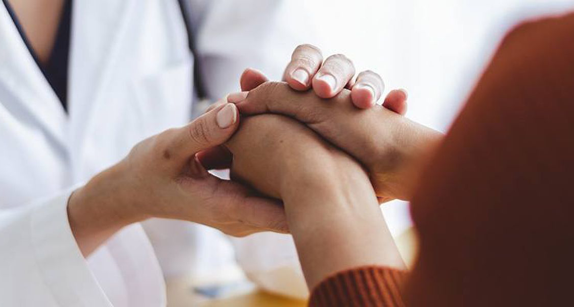 doctor holding patient's hands