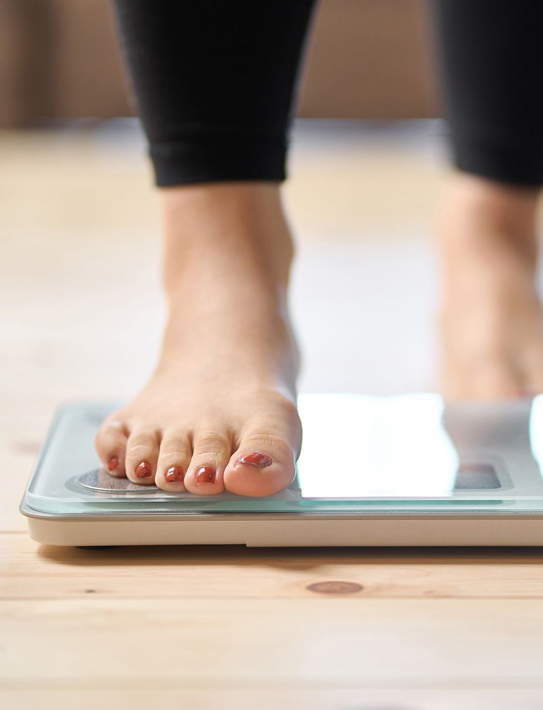 foot stepping onto a scale