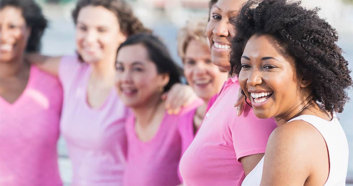 Women smiling and wearing pink