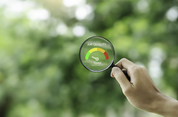 hand holding an air quality magnifying glass