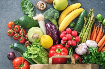 Veggies coming out of a grocery bag