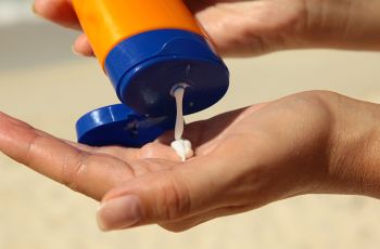 Sunscreen being squeezed into someone's hand