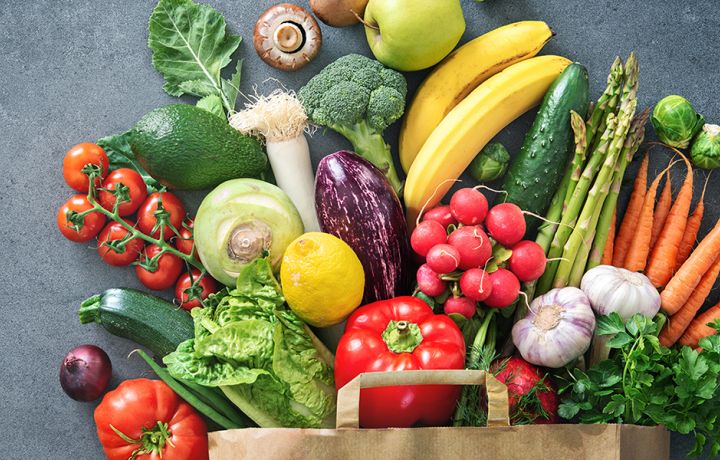Veggies coming out of a grocery bag